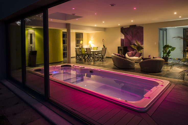 Swim spa with pink lighting